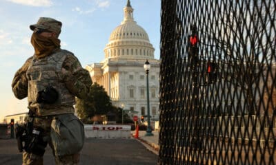 A member of the New York National Guard stands at a gate outside the U.S. Capitol the day after the House of Representatives voted to impeach President Donald Trump for the second time January 14, 2021 in Washington, DC.