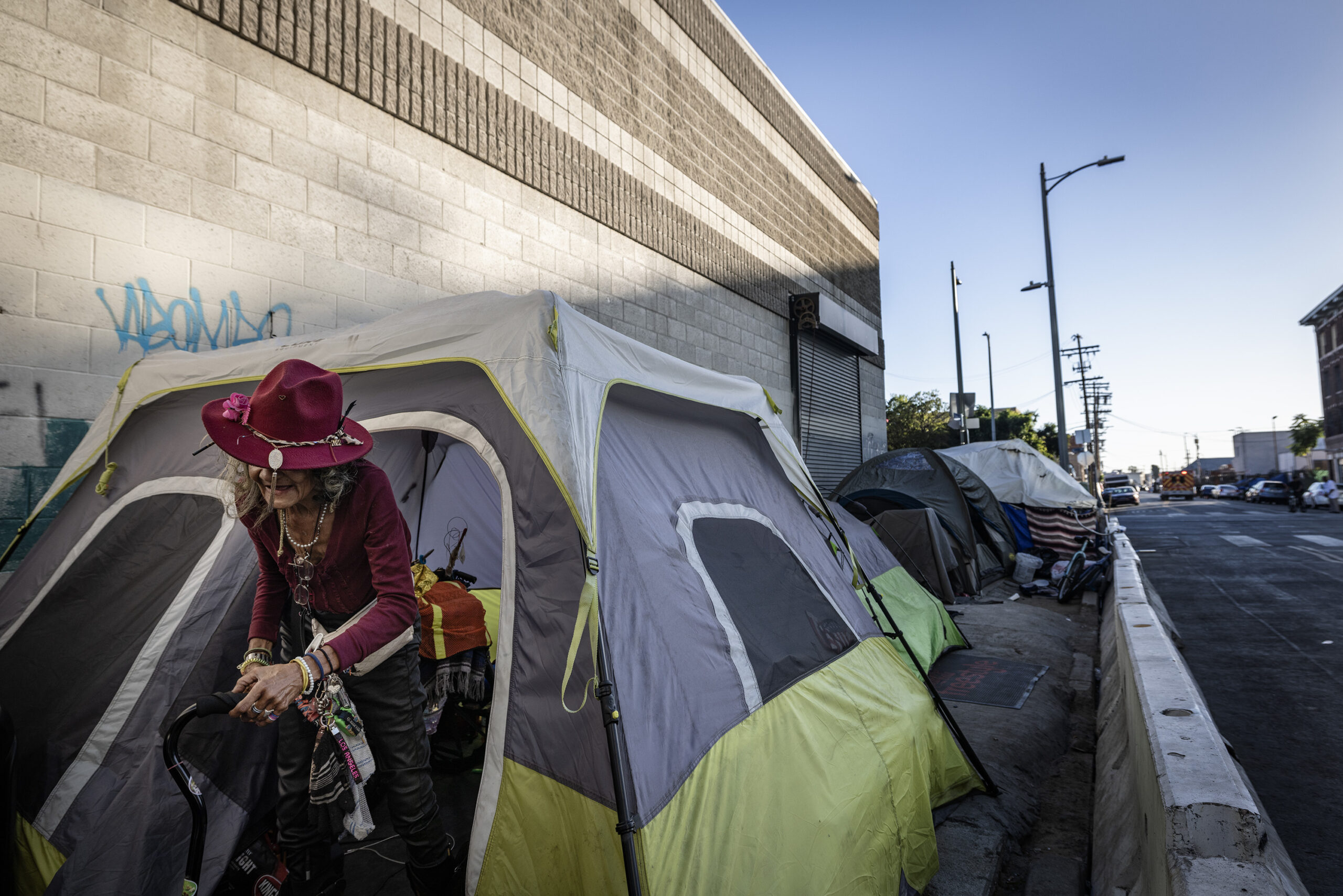 Barbie Carter, a former denizen of Skid Row, walks out of a tent — which is Brown’s “office.”