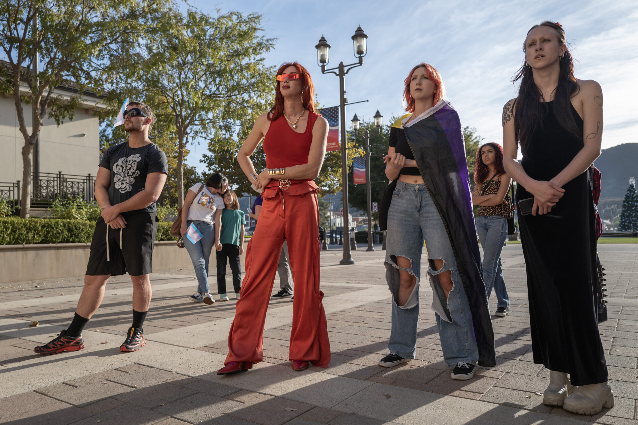 Activists, including Love Bailey (in orange), attend the rally at the steps of Temecula’s civic center. Bailey, who runs Savage Ranch — a queer refuge and artist commune in Temecula — regularly attends school board meetings to speak out against the right wing majority on the board.