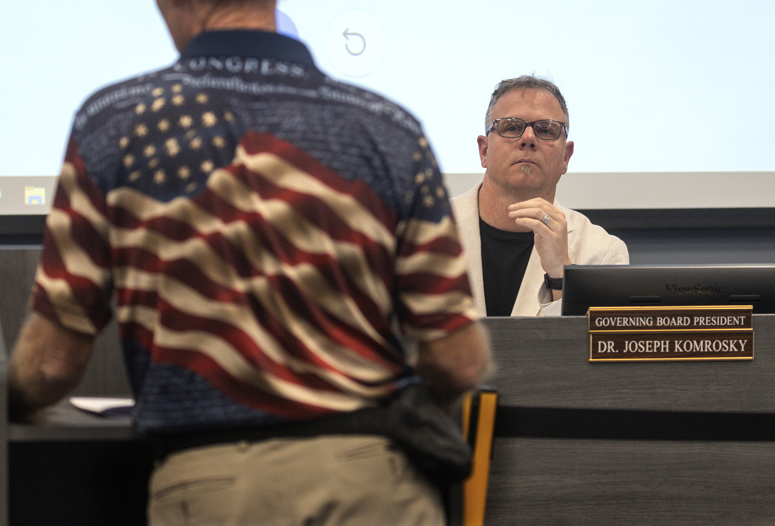 School Board President Joseph Komrosky listens to a speaker during a board meeting on Nov. 14.